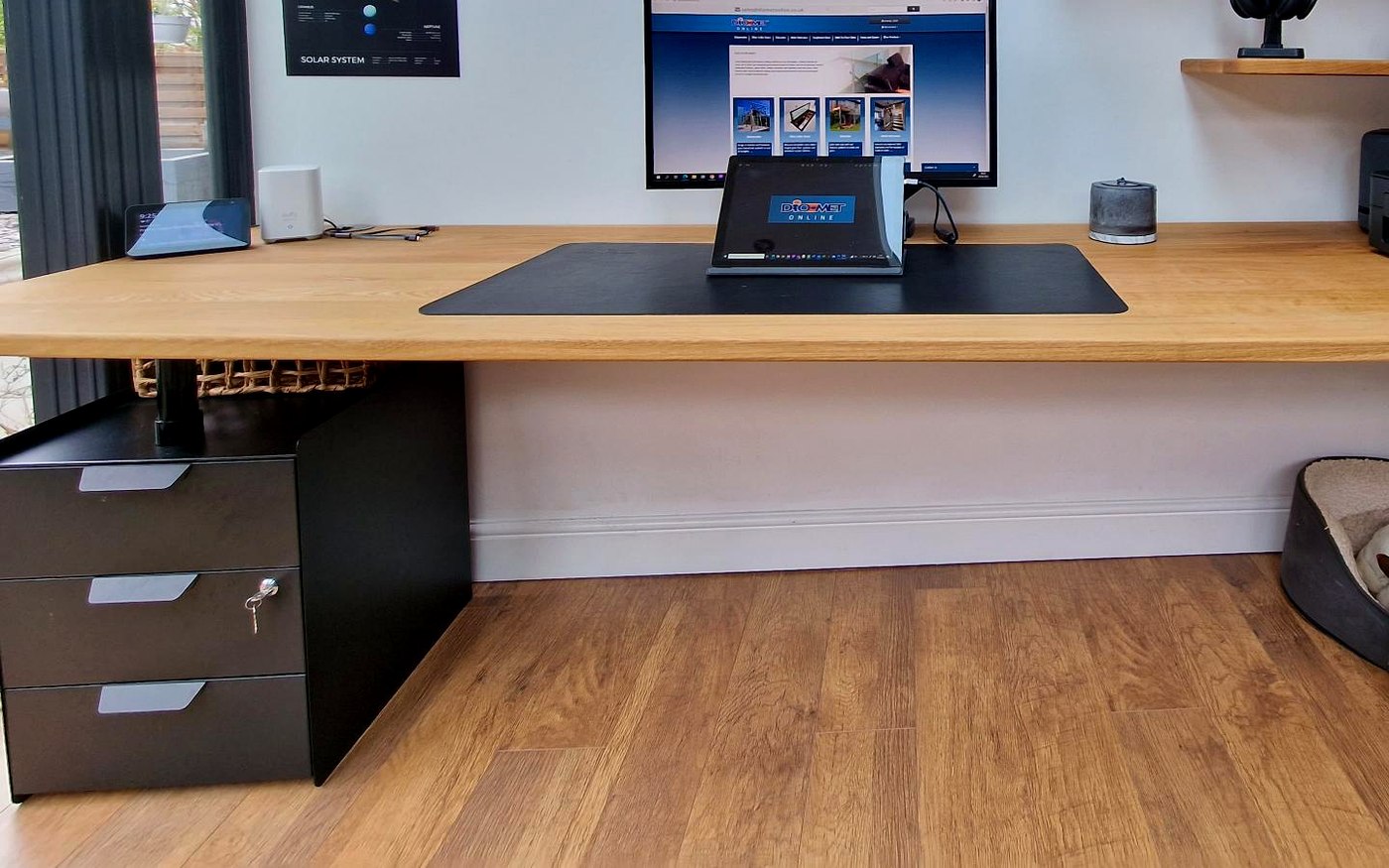 30mm solid oak desk spanning clear with no legs on a hidden steel support, with black steel drawers, Sheffield